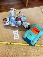 Pig figurine and car bank with measuring tape