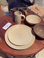 Dinner plates, bowls, mugs displayed on table