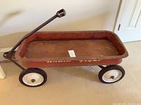 Side view of Radio Flyer metal wagon showing handle and wheel layout