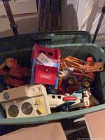 Assorted vintage plastic toys inside tote