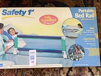 Front of boxed Safety 1st portable bed rail showing product image and branding