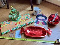 All items grouped: pop-up book open, ornaments, tray, placemat, mug