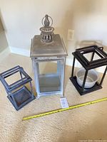 All three lanterns aligned with measuring tape for scale