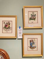 All three framed needlepoint rabbit pieces on wall