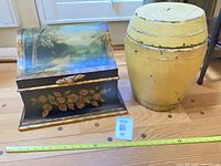 Chest and barrel side by side with measuring tape for scale