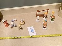 Overview of both nativity sets laid out with measuring tape