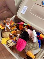 Top view of bin with assorted plush turkeys and scarecrow pieces visible