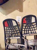 Pair of Trappe of Aspen snowshoes showing lattice design, brand label and bindings