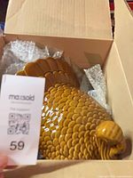 Brown ceramic turkey cookie jar inside cardboard box with bubble wrap