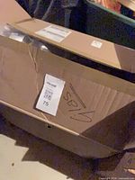 cardboard box containing the wrapped vases