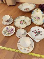 Group shot of porcelain teacups, plates, heart dishes, serving bowl and platter