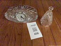 Desk clock and crystal bell on wooden surface