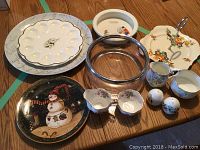 Photo showing all serving pieces including plates, egg platter, glass bowl, shakers, and bone china sets