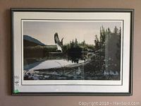 Full view of the framed print showing the eagle flying over a river with trees and mountains in the background.