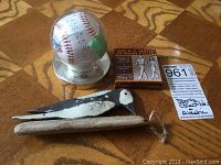 Photo showing all three items: autographed baseball, Walk-A-Matic gauge, and woodpecker decor on wooden floor.