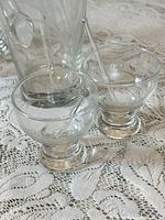 Two of the footed cups with stirrer visible