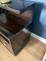 nightstand front view showing tiers, open shelf, drawers