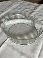 Round glass Pyrex casserole with etched star pattern on rim