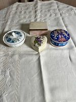 Group view of four ceramic lidded boxes