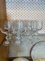 Group of etched crystal goblets on shelf