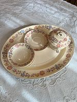 Top view of platter with bowls, saucer, covered sugar bowl
