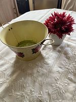 Metal planter interior and exterior with vase of flowers