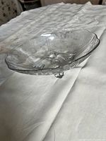 Top view showing scalloped rim and etched floral pattern of glass oval dish