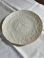 Front view showing raised relief lovebird and floral design on ivory bone china plate