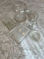 Group shot of all glass pieces on lace cloth