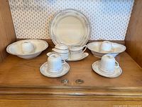 Group view of Noritake Rothchild china pieces on shelf