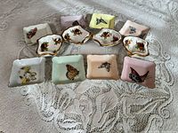 Overview of all eleven tea-bag dishes showing shapes, motifs and colours