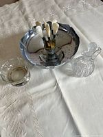 stainless bowl with picks, crystal bowl, crystal decanter on table