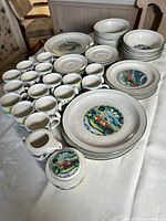 Full set on table showing plates, bowls, cups, serving pieces