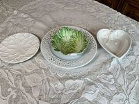 Group overview showing three visible dishes (flower plate, pierced charger with cabbage plate on top, heart dish)