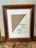 Front view of brown wood frame with mat insert