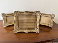 All three ornate gold wooden frames displayed
