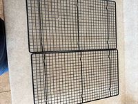 Top-down view of both black cooling racks showing full grid pattern and overall condition