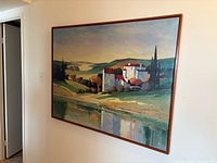 Framed landscape oil painting mounted on wall