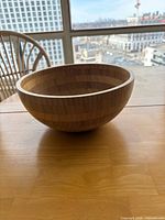 side view of wooden salad bowl on table