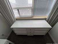 Full front view of dresser under window