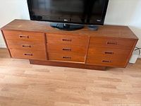 front view showing nine drawers and TV on top