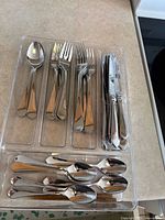 Tray holding assorted cutlery pieces