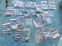 Overview of all resealable bags with assorted costume jewelry pieces on blanket