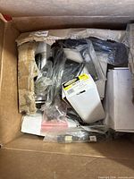 Box with multiple packaged commercial hinges and hardware