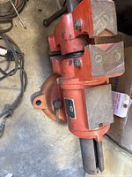 Full view of red King bench vise showing jaws, swivel base and mounting flange