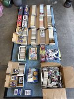 Full lot overview showing long cardboard boxes, sealed sets, small boxes and loose cards