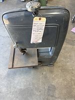 Front view of gray Craftsman band saw with tag attached