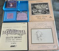 All five items laid out: open blue book & CD set, BBC jewel-case CD, two Angel Records ballet LPs, London ffrr Rossini box