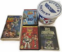 Group shot of VHS, three DVDs and closed Bucket O Soldiers