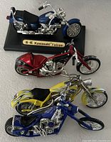 Four model motorcycles grouped on table